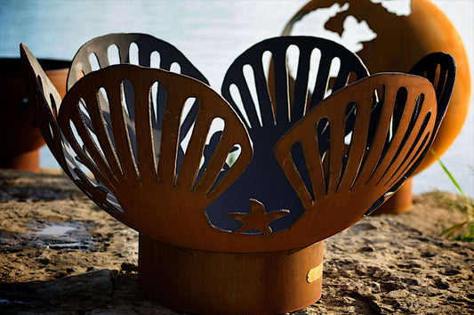 The beautiful Barefoot Beach Fire Pit, displayed on the lake shore.