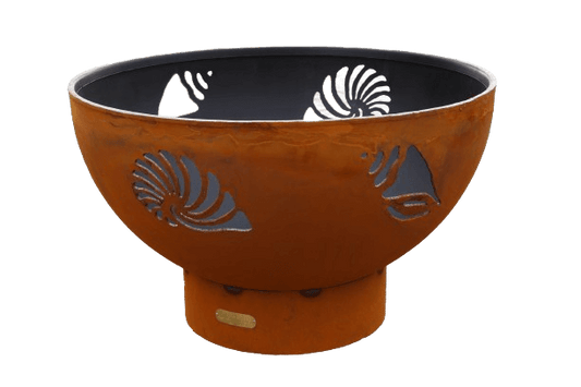 The Beachcomber Fire Pit with shell cut outs, on a white background