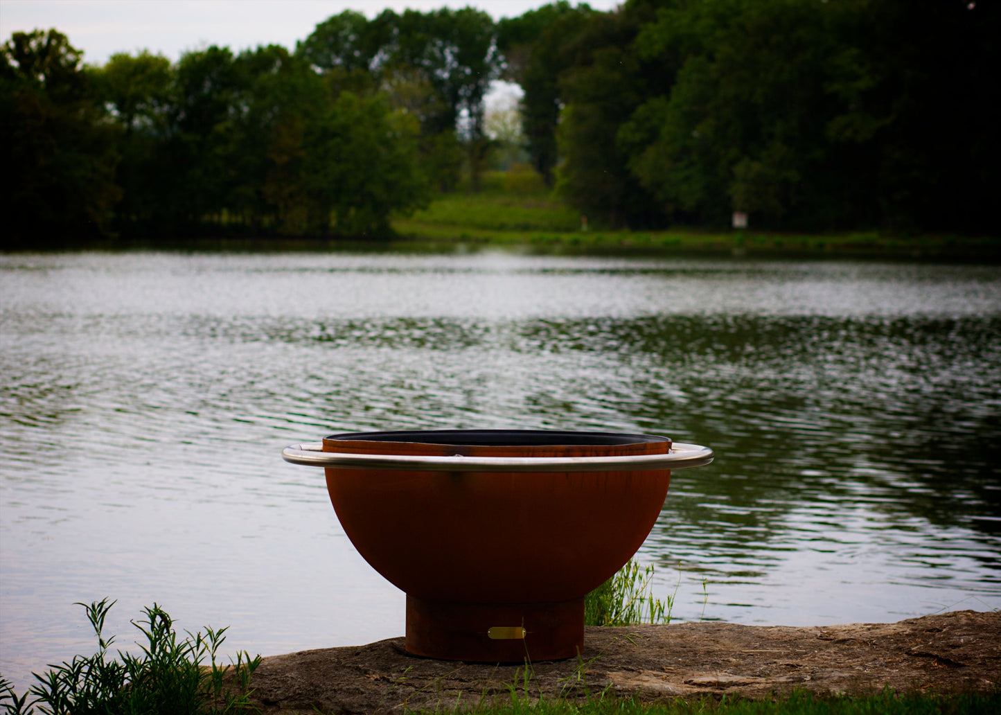 The Bella Luna Fire Bowl Displayed on the lake side shore, from a low angle point of view.