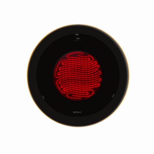 Round black heating element with red interior on a white background