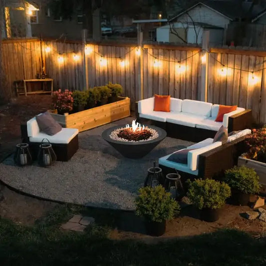 The Cairo Concrete Fire Bowl 02, displayed with the Graphite finish in a backyard Garden, surrounded by cozy outdoor furniture.