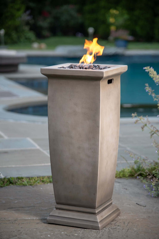 The 28 X 11 inch MGO Gas Outdoor Fire Pit, displayed on a poolside patio, with a warm flame.