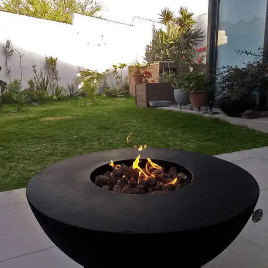 Venecia Concrete Fire Bowl 01, displayed in the Noir Color option on a outdoor patio.