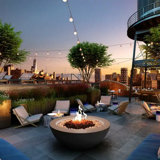 The Venecia Concrete Fire Bowl 04 Displayed on top of a high rise balcony, in the middle of the city.