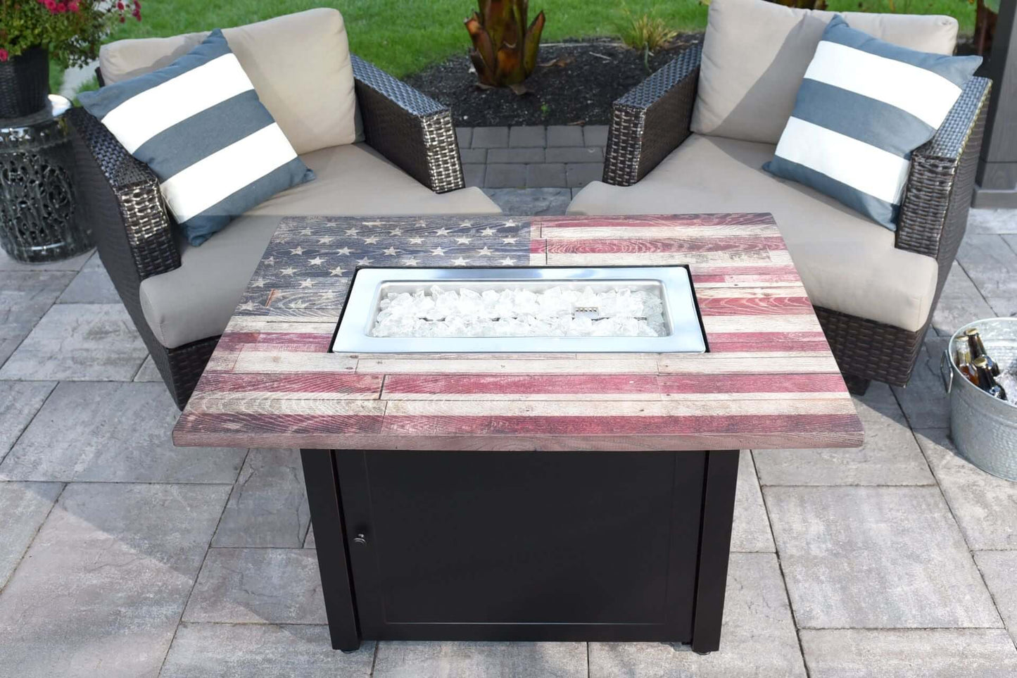 The Americana, 40 x 28 Rectangular Gas Outdoor Fire Pit, showing its beautiful american flag design on a cozy backyard Patio.