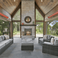 Outdoor patio with wicker furniture, fireplace, and scenic view using the Bromic Cobalt Electric Patio Heater.