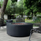 The Coliseo Concrete Cylinder Fire Pit 01 in the Noir Color option, displayed on a beautiful backyard patio.