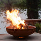  The Emperor Fire Pit, shown on an outdoor patio, with a huge warm flame.