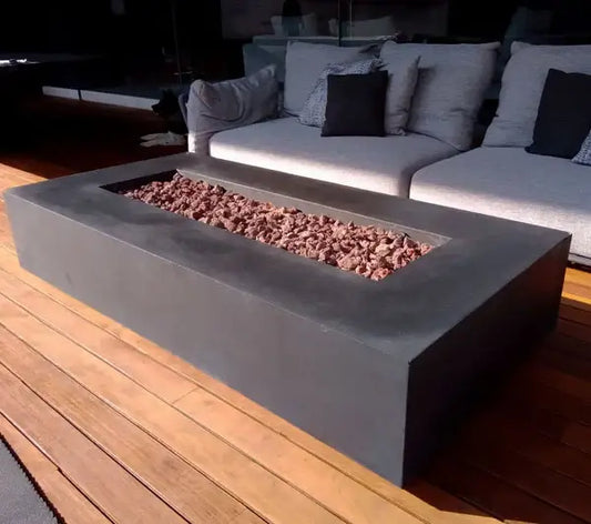The Elegant Manhattan Concrete Rectangular Fire Pit 03, displayed in the Noir color option on a outdoor patio