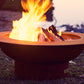 The Handcrafted saturn fire pit displayed on a lakeside shore with a huge warm flame.