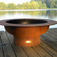 The Handcrafted Saturn fire pit displayed on a lakeside dock.