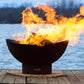 The Beautiful Scallop Fire Pit, displayed on a lakeside dock, with huge warm flame.