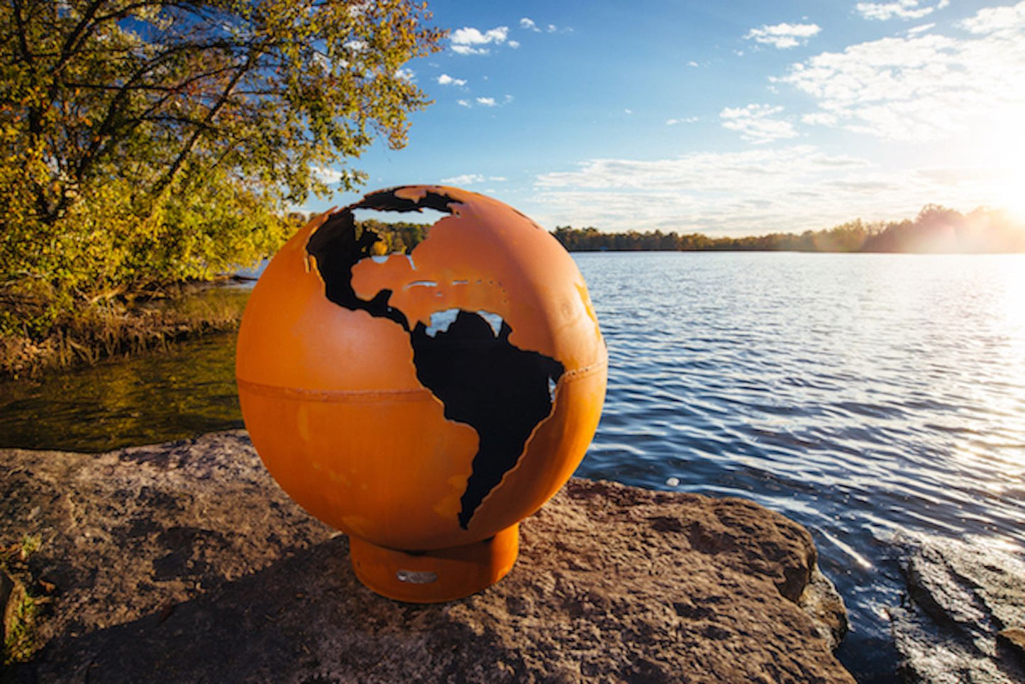 The Third Rock Fire Pit, Displayed on a lakeside rock.