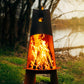 The Vesuvius wood burning fire pit, Displayed in a backyard, with a huge warm flame.
